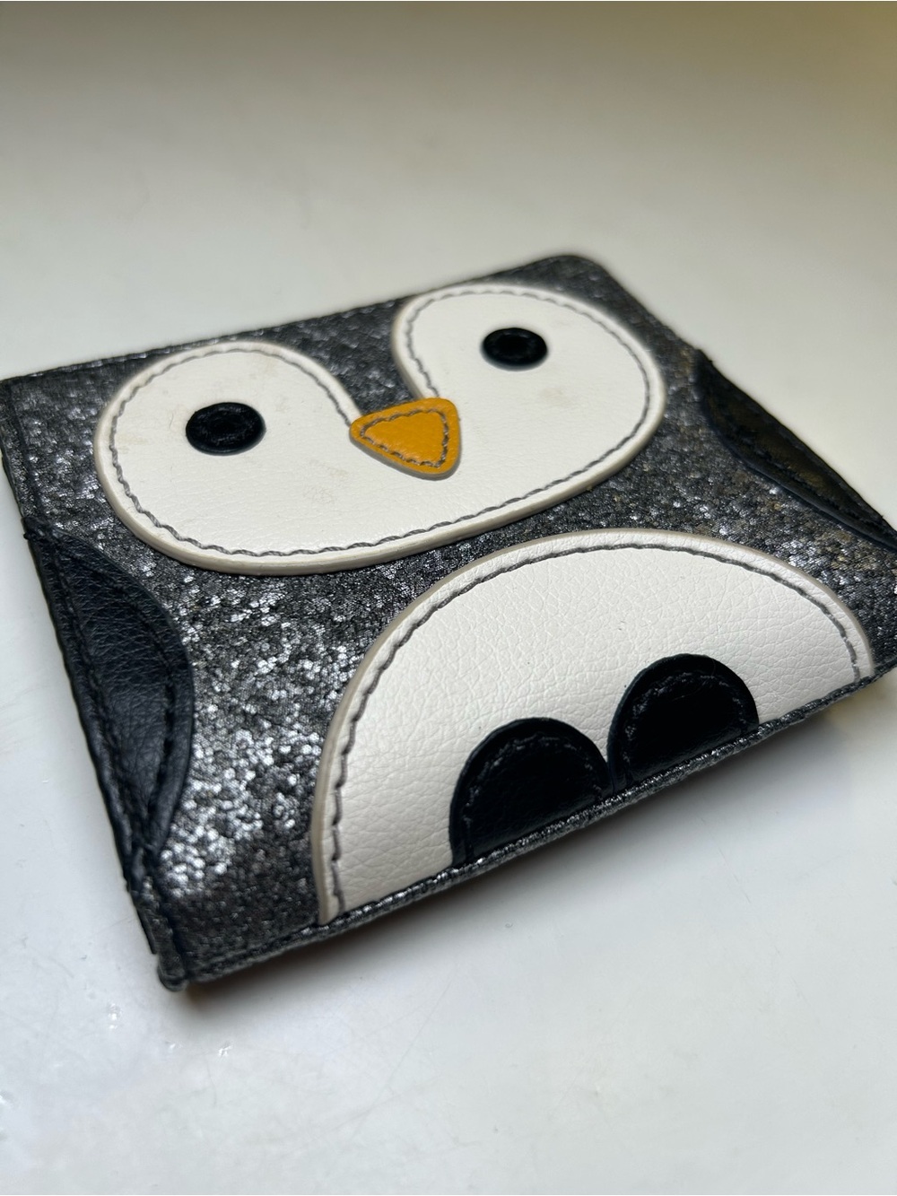 Fossil Penguin Bifold Wallet, Black, White and Silver-Grey Glitter.